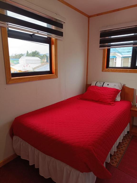 Postel nebo postele na pokoji v ubytování Hostal B&B Coastal Natales