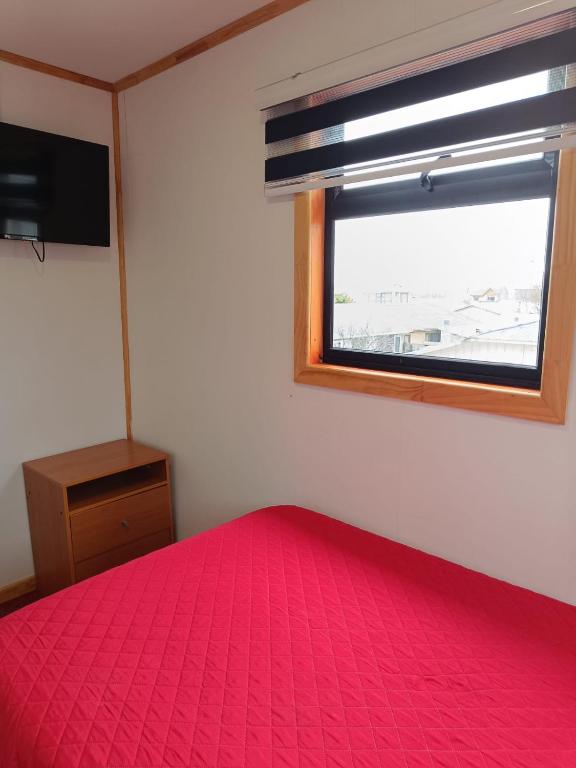 Postel nebo postele na pokoji v ubytování Hostal B&B Coastal Natales
