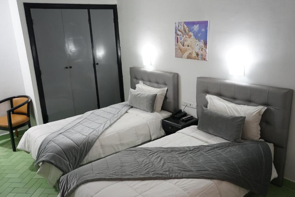 Postel nebo postele na pokoji v ubytování Hotel Nouzha