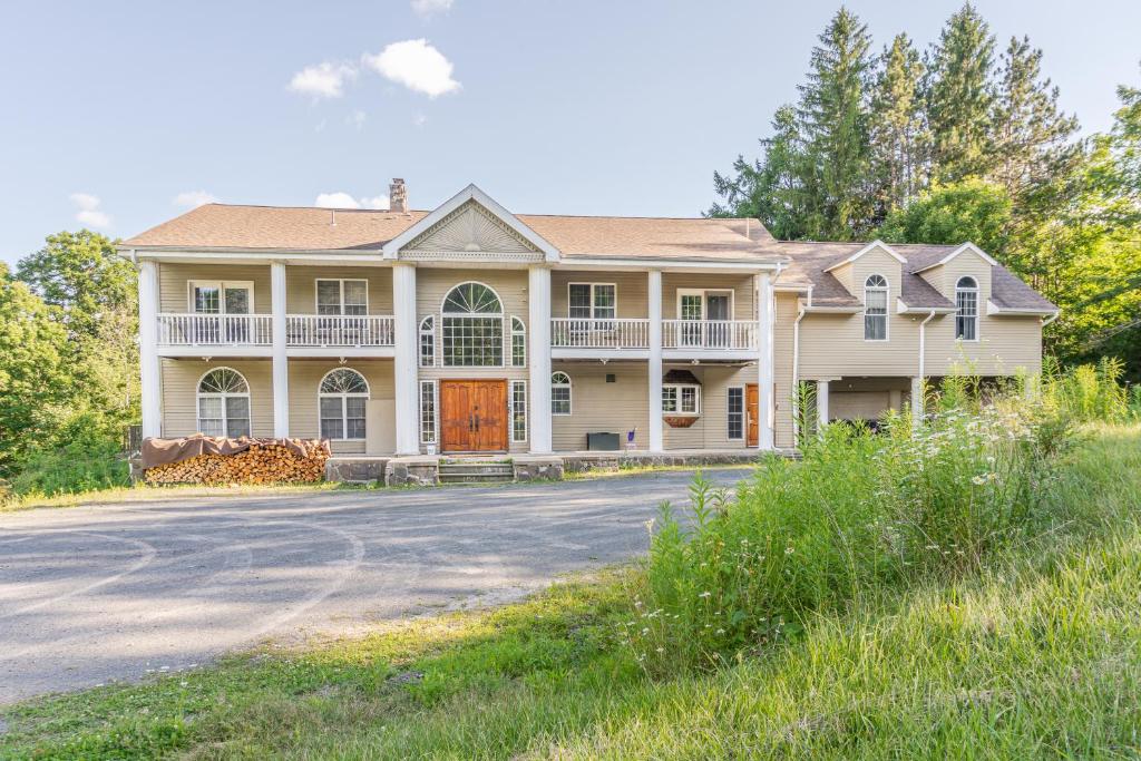 a large house with a road in front of it at Maplewood Manor 8BR, Hot Tub, Gym, Fire Pit in Jewett