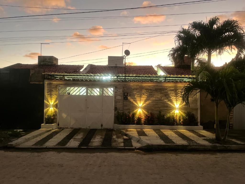 a house with lights on the front of it at Casa com Piscina individual in Paulista