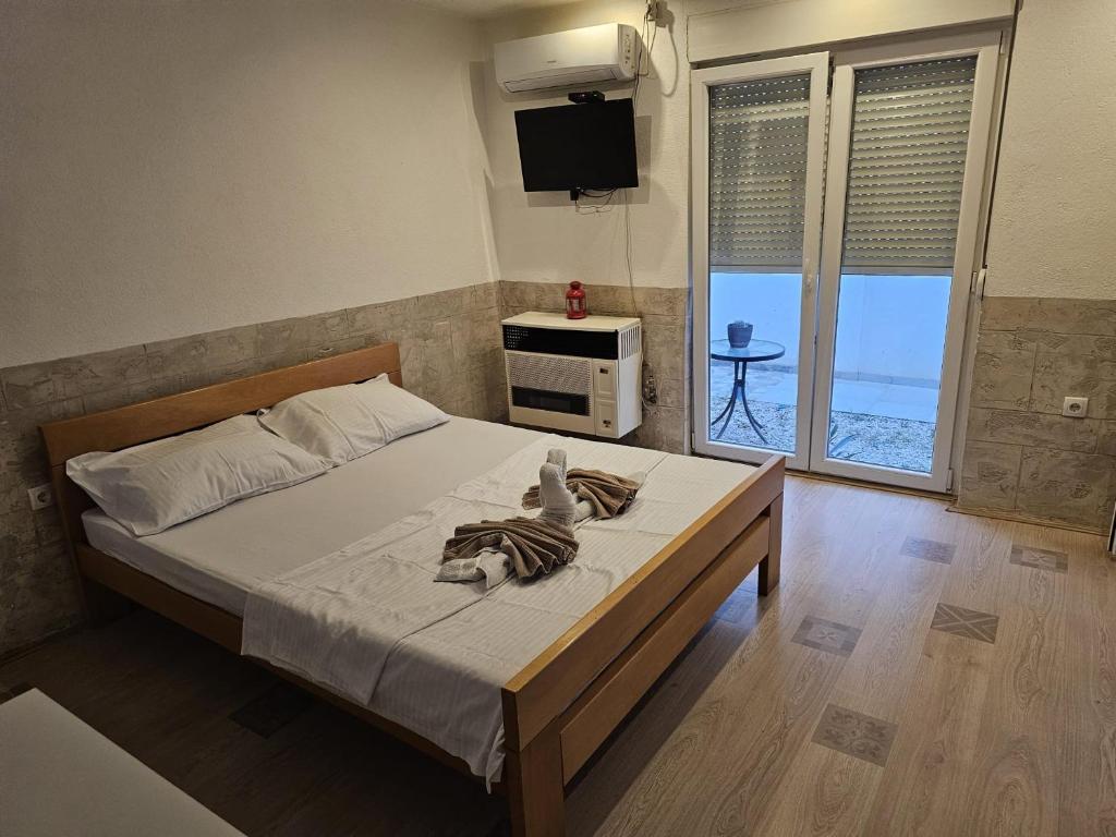 a bedroom with a bed with a zebra decoration on it at Relax apartmani in Kragujevac