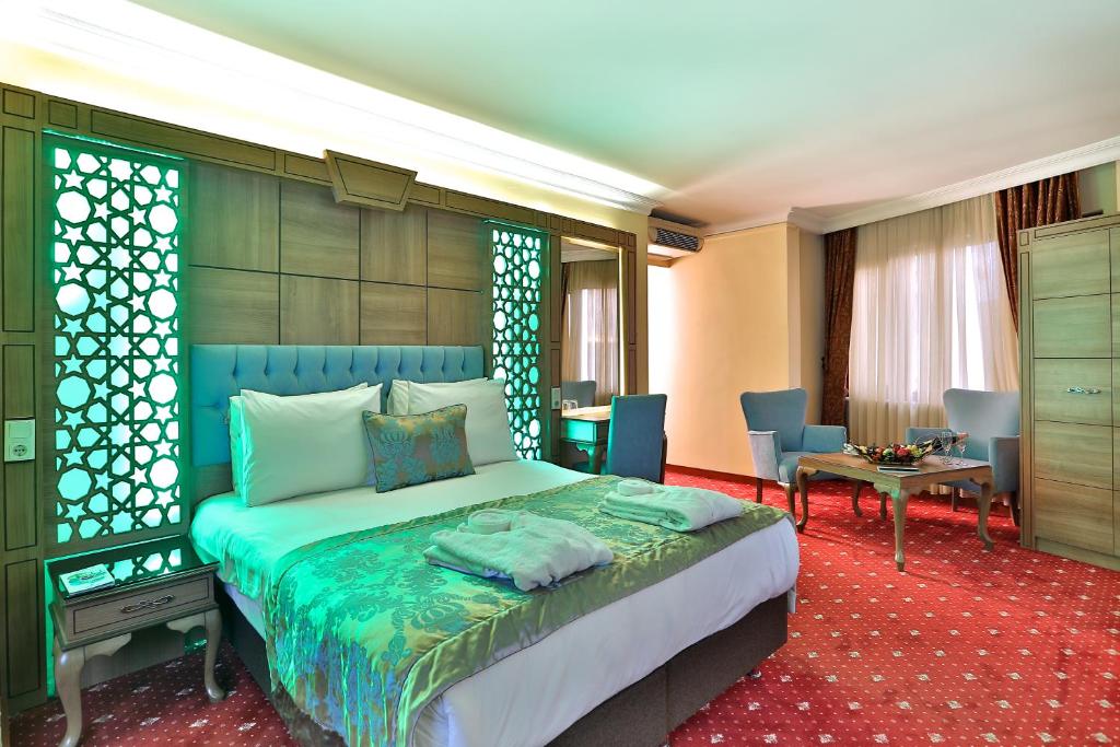 イスタンブールにあるブドー ホテルのベッドルーム1室(ベッド1台、テーブル、椅子付)