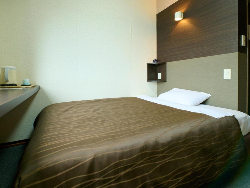 Postel nebo postele na pokoji v ubytování Tabist Hotel Seishokan