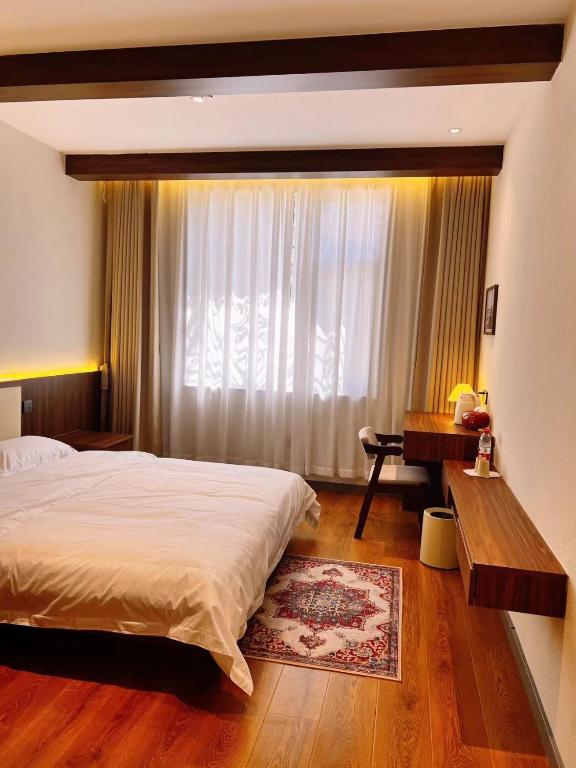 Postel nebo postele na pokoji v ubytování Kashgar QIu Ge Homestay