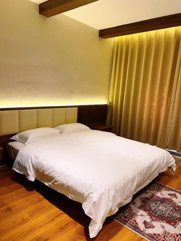 Postel nebo postele na pokoji v ubytování Kashgar QIu Ge Homestay