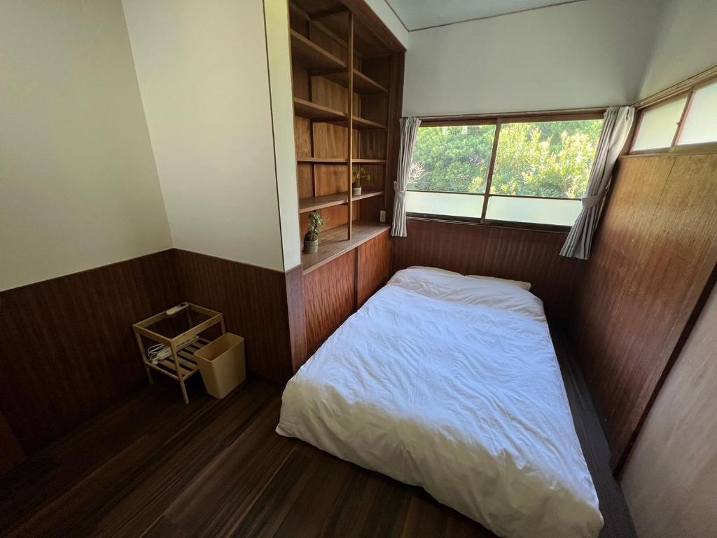 Postel nebo postele na pokoji v ubytování 湊庵 路考茶-so-an rokocha-