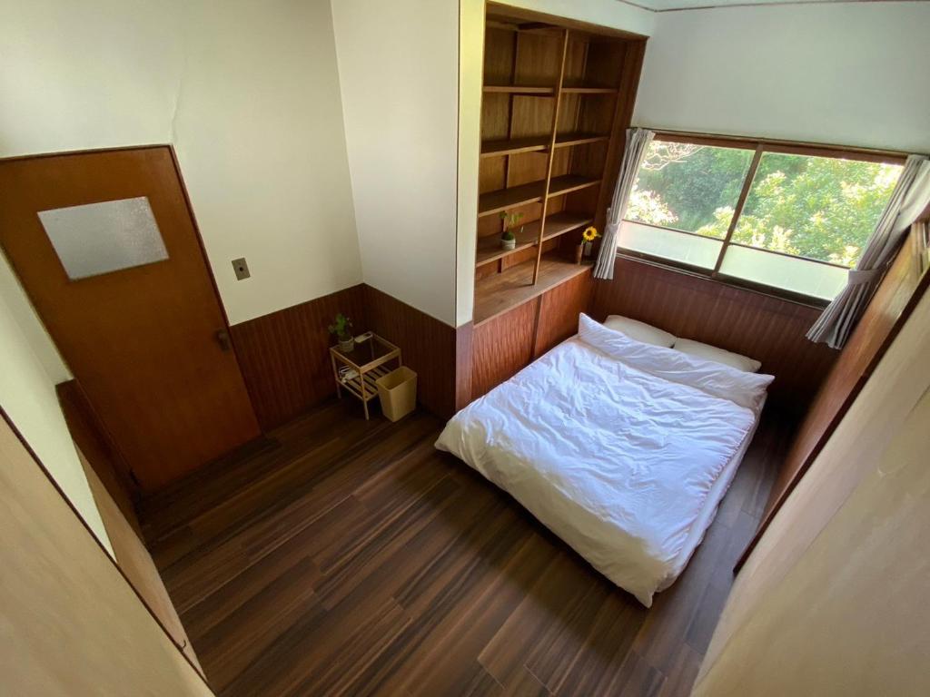 Postel nebo postele na pokoji v ubytování 湊庵 路考茶-so-an rokocha-