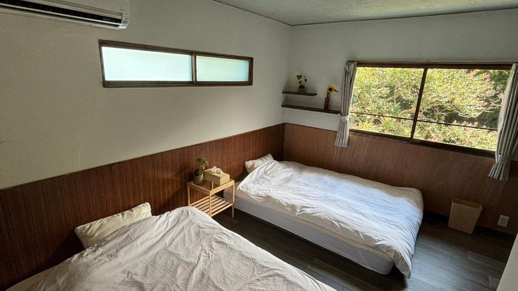 Postel nebo postele na pokoji v ubytování 湊庵 路考茶-so-an rokocha-