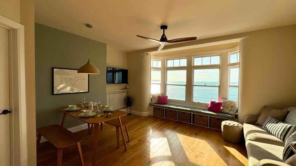 a living room with a table and a couch at The Panoramic - Beach Front Apt - No Guest Fees in Kent