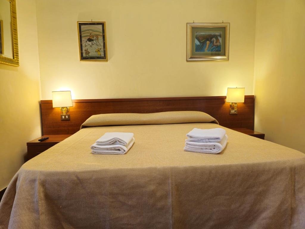 Postel nebo postele na pokoji v ubytování Hotel Azzurra