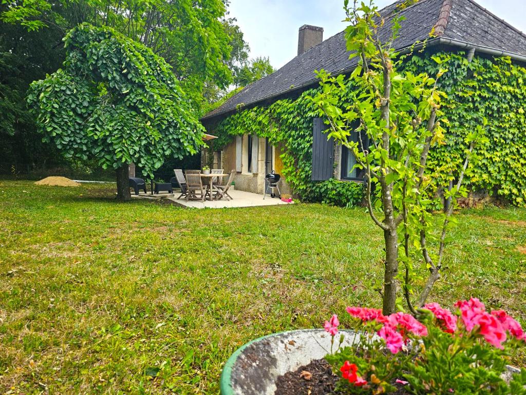 a house with a small tree in a yard at La Crocherie : Gîte des Elfes - Free Wifi & Smart TV in Beaumont-Pied-de-Boeuf