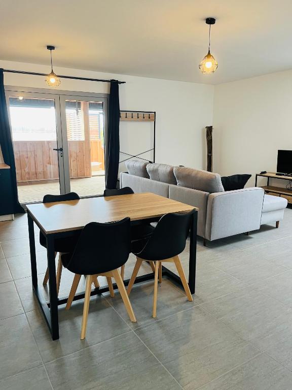 un salon avec une table, des chaises et un canapé dans l'établissement Spa, à Marcheprime