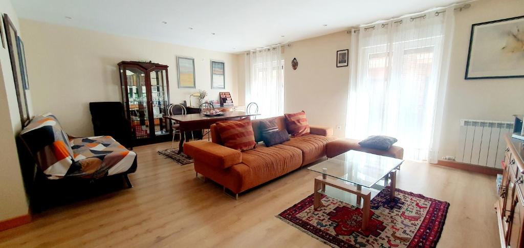 a living room with a couch and a table at Despertar en León, al lado de la Catedral in León