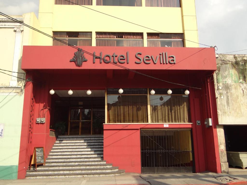 a red building with a red door and stairs at Hotel Sevilla in Guatemala