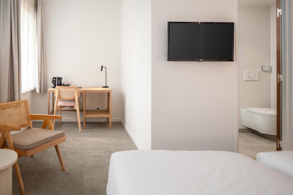 TV a/nebo společenská místnost v ubytování Hotel Chamade