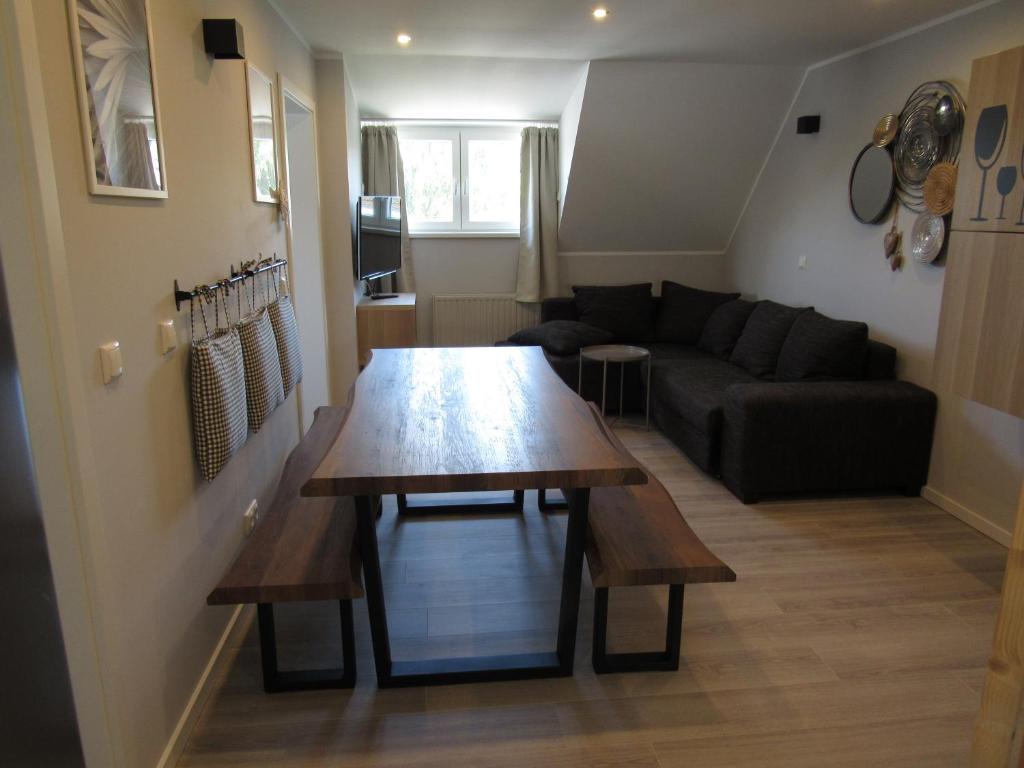 a living room with a table and a couch at Ferienwohnungen Rheinhöhe in Sankt Goar