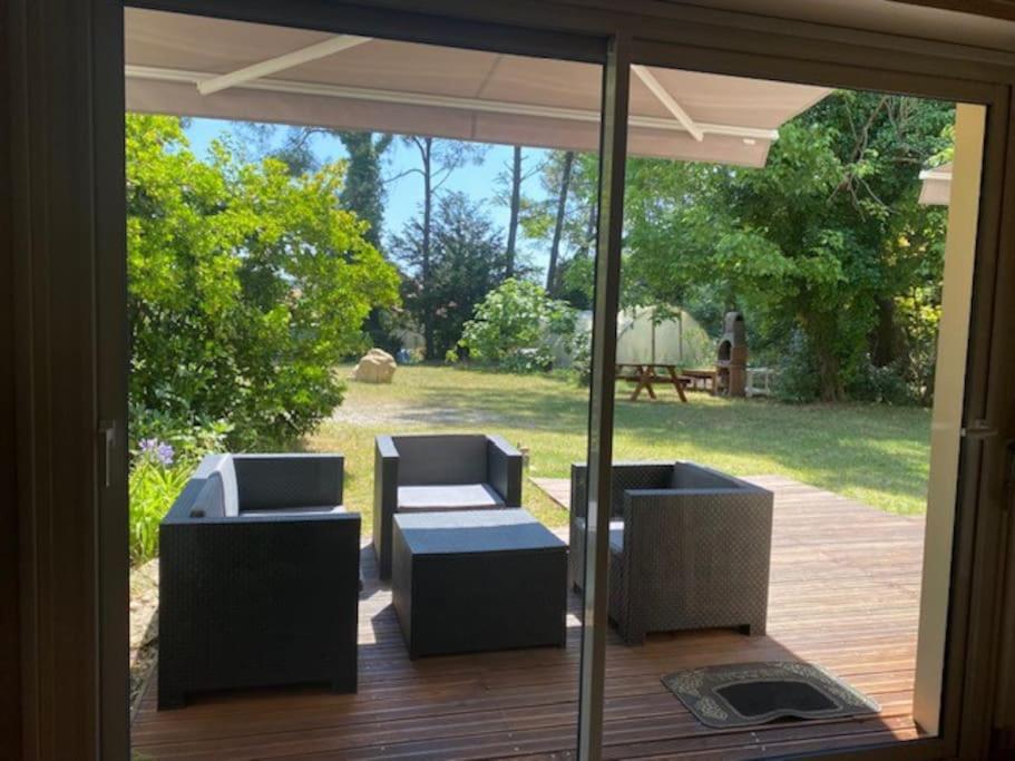 - une véranda avec 2 chaises et une table dans l'établissement Vaste appartement, jardin, proximité océan, à Capbreton