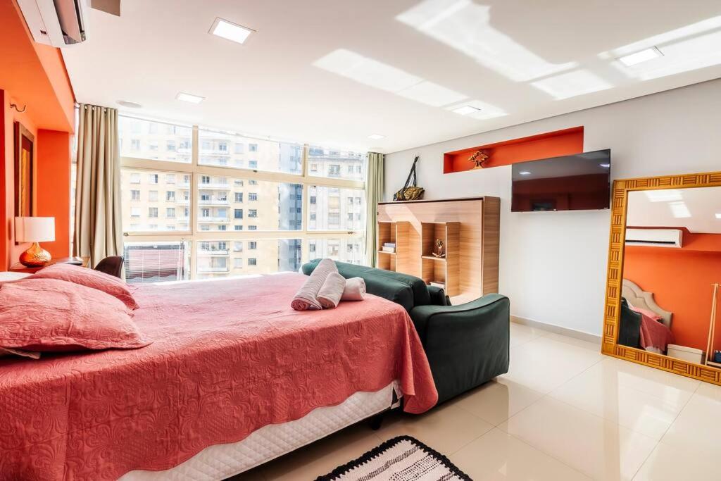 a bedroom with a large bed and a mirror at Aconchego em sampa in Sao Paulo