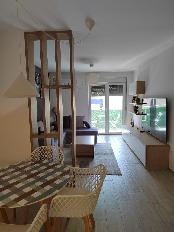 a living room with a table and chairs and a couch at Lovely one bedroom apartment in Ub