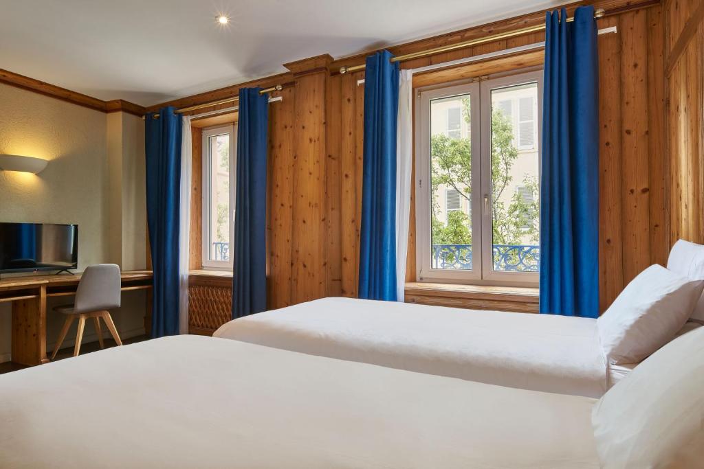 Postel nebo postele na pokoji v ubytování Hôtel de l'Europe by HappyCulture