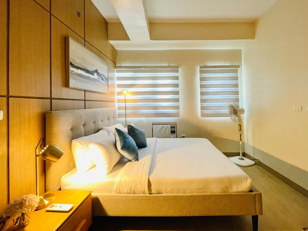 une chambre avec un lit avec des oreillers et une fenêtre dans l'établissement 15 Elegant Urban Suite, à Cari Mayor