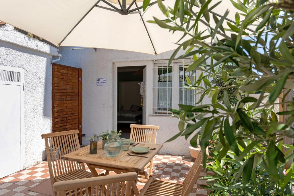 デセンツァーノ・デル・ガルダにあるIl Sire - Casa Vacanzaのパティオにある木製のテーブルと椅子