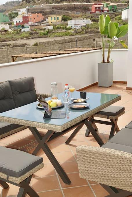 a table and chairs on top of a balcony at Los Adejo in Moya