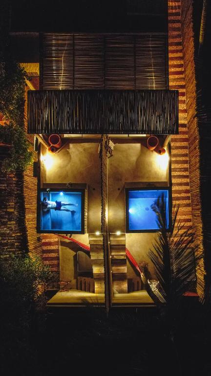 a building with two windows with lights on it at Pousada Zinga Vila de Caraíva in Caraíva