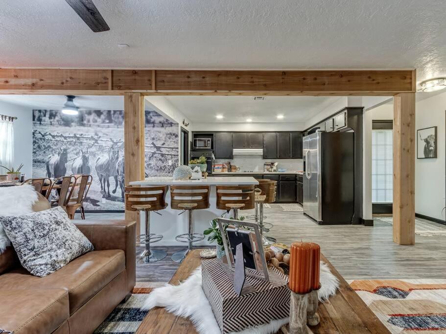 a living room with a couch and a kitchen at Country home near Norman on 5 ac in Newcastle
