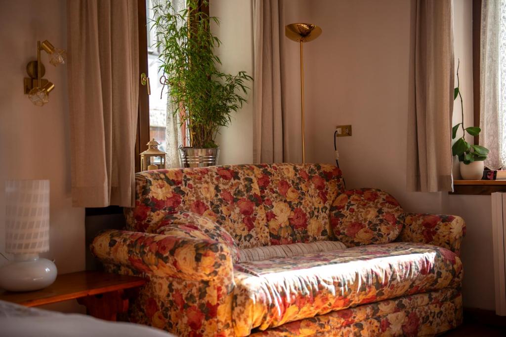 a living room with a couch and a window at Masito Apartments The Hub in Cortina dʼAmpezzo