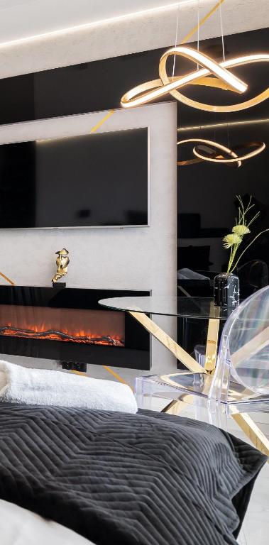a bedroom with a bed with a black and gold headboard at Gold Room in Szczecin