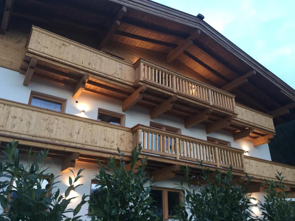 a building with wooden balconies on the side of it at Appartementhaus Schubert in Westendorf