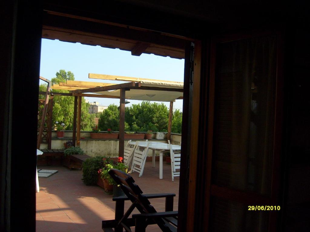 a view of a patio with a table and chairs at B&B Il Parco in Civitavecchia