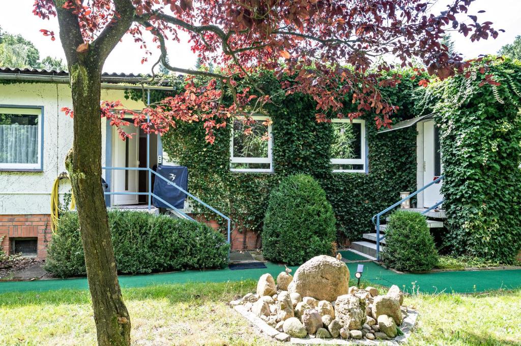 a house with a bunch of rocks in front of it at Ferienwohnung am Wald in Hagenow