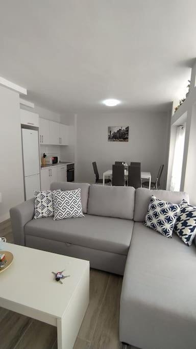 a living room with a couch and a table at Apartamento Refugió del Mar in El Médano