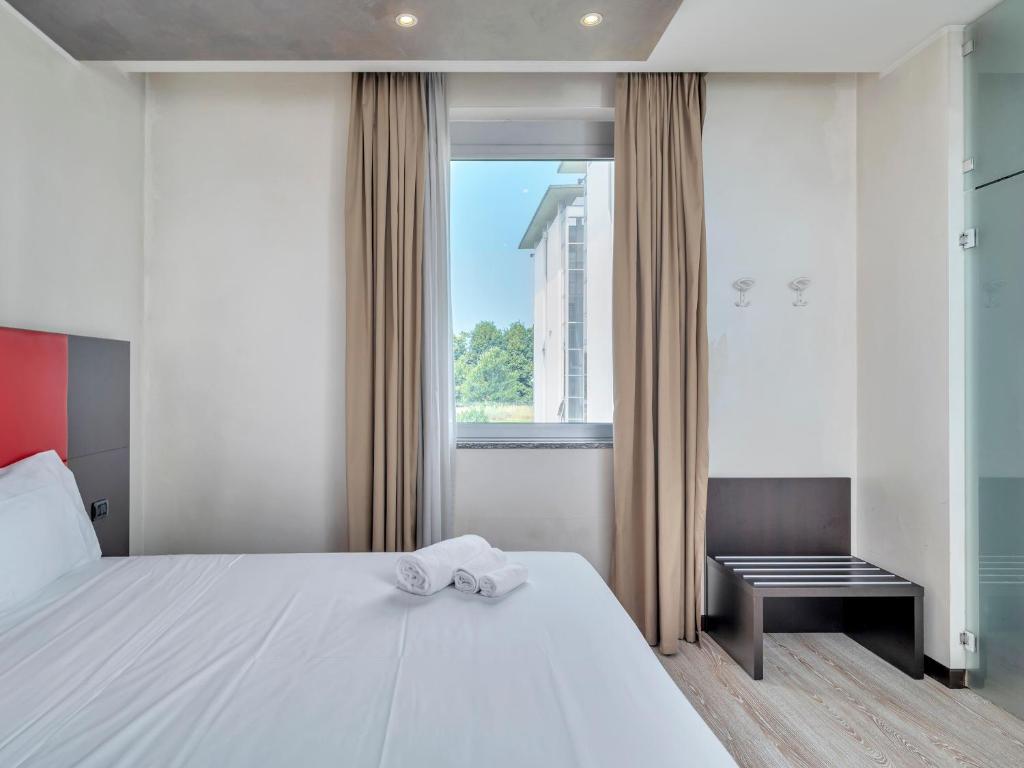 Postel nebo postele na pokoji v ubytování B&B HOTEL Park Hotel Cassano