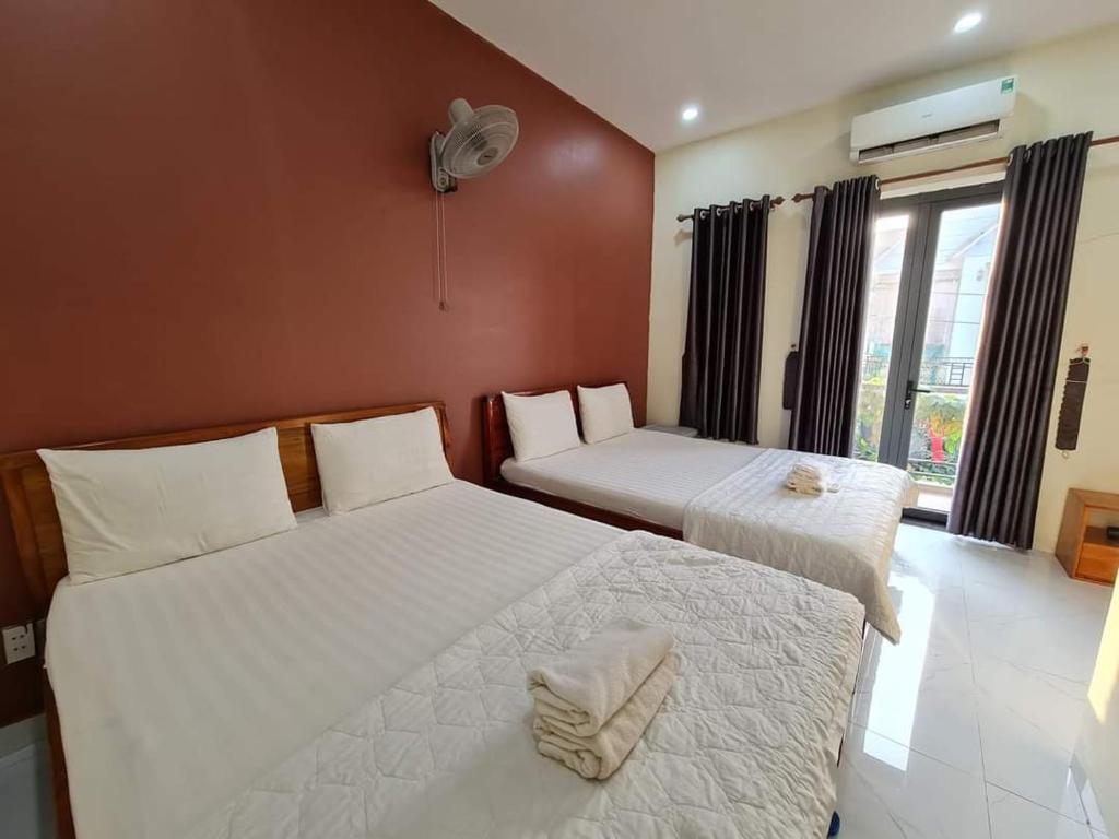 Postel nebo postele na pokoji v ubytování Motel Happy House Nhơn Trạch
