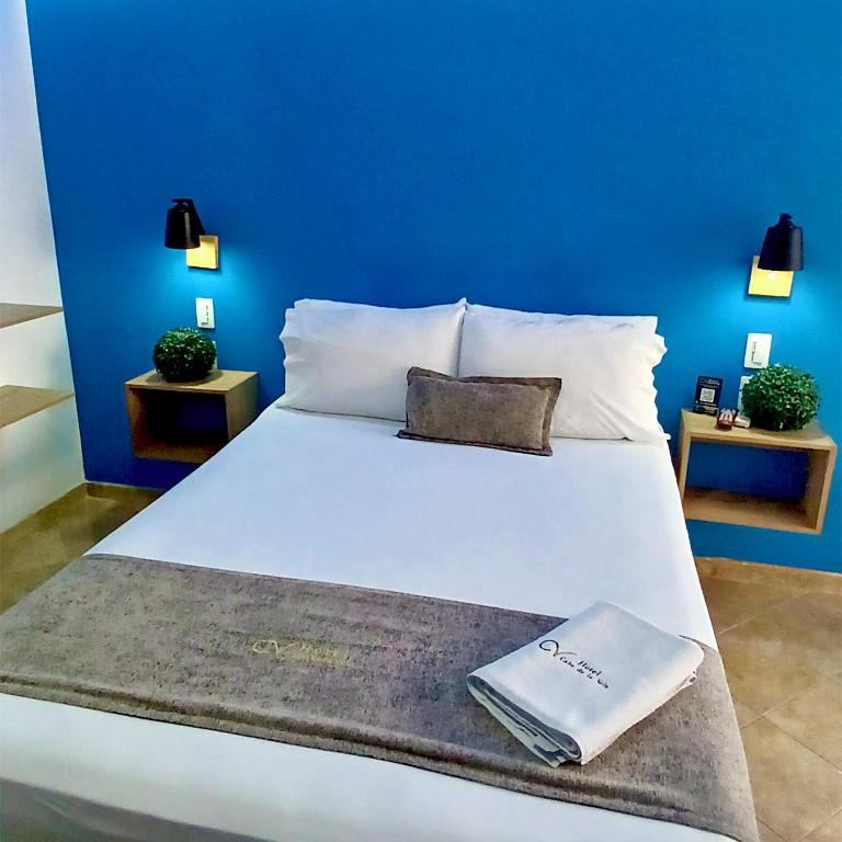 Postel nebo postele na pokoji v ubytování Hotel Cabo de la Vela Medellin