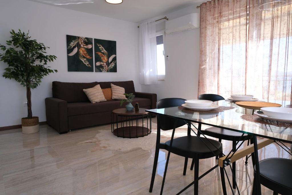 a living room with a table and a couch at Seaside Serenity "Earth" with pool, 150m from sea in Sukošan