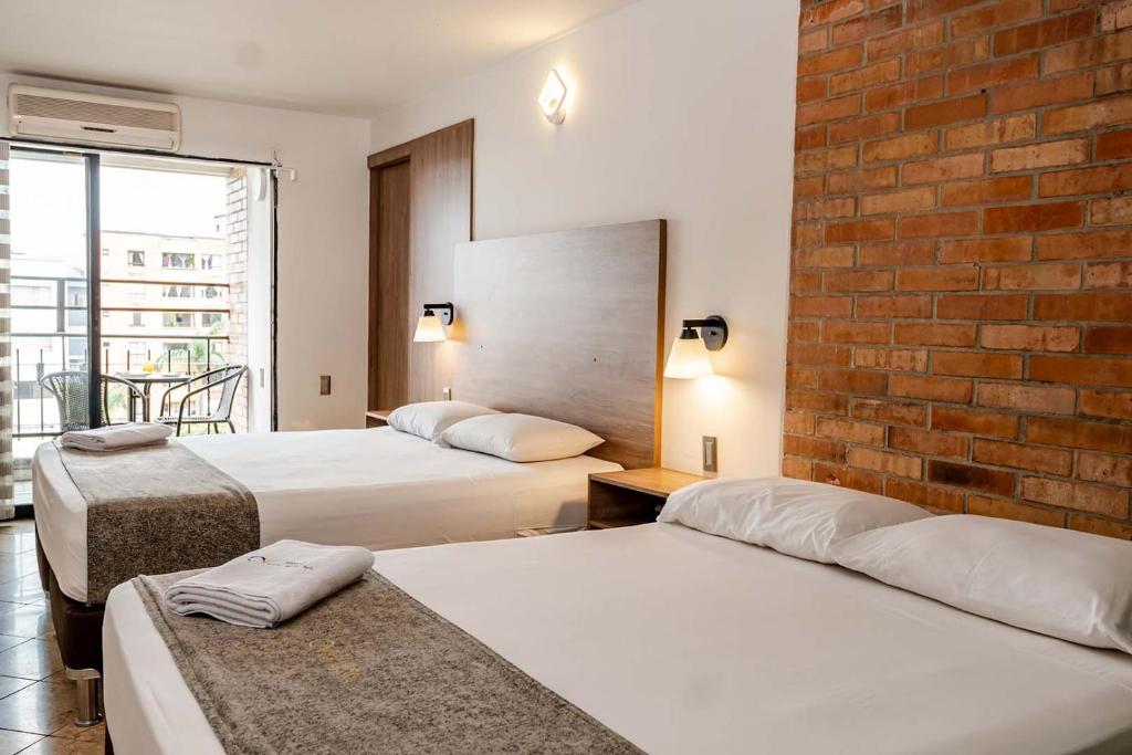 Postel nebo postele na pokoji v ubytování Hotel Cabo de la Vela Medellin