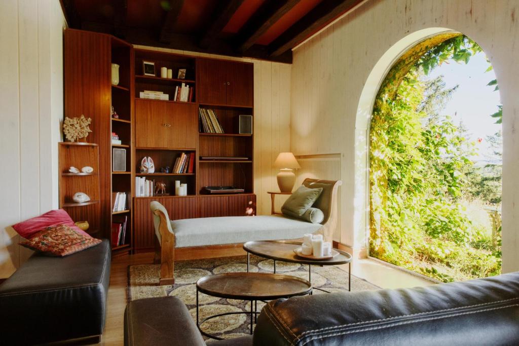 a living room with a couch and a table at Domaine Foray in Villecien