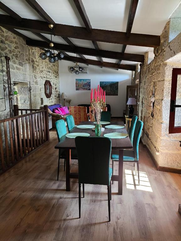 a dining room with a table and chairs at Xiravai-Ribeira Sacra in Peares