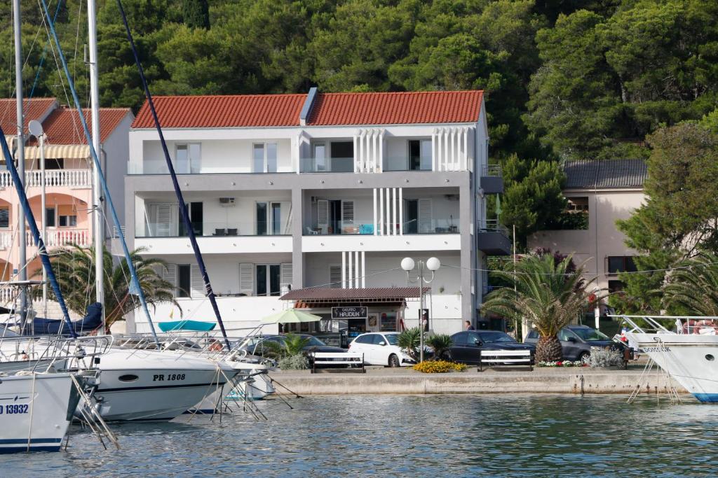 a large building with boats docked in a marina at Apartmani Mary S2 in Kukljica