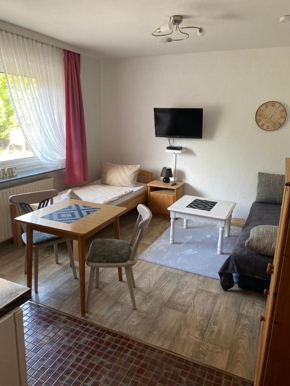 a living room with a couch and a table at Appartement Pension Feist in Dagebüll