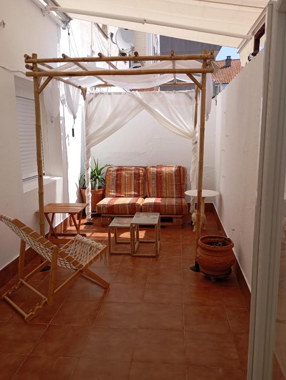 a living room with a couch and a pergola at Appartement avec terrasse in Santoña