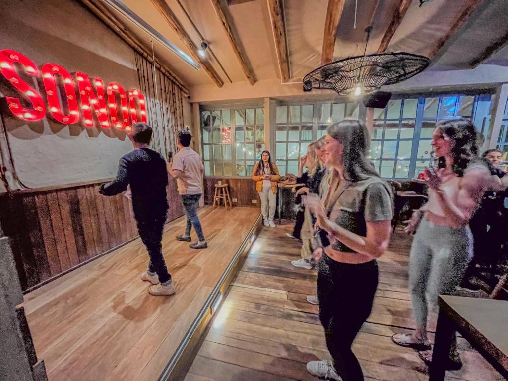 a group of people dancing in a room at Viajero Cusco Hostel in Cusco