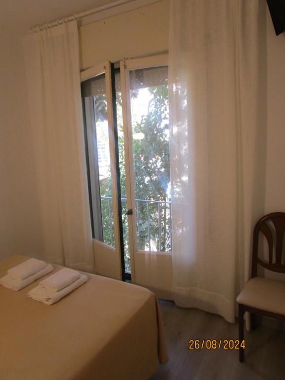 Postel nebo postele na pokoji v ubytování Hotel Apartaments Gesòria Porta Ferrada