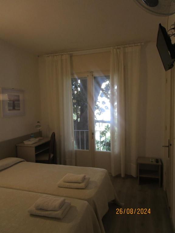 Postel nebo postele na pokoji v ubytování Hotel Apartaments Gesòria Porta Ferrada