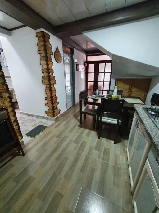 a living room with a table and a dining room at Apartamento N2 completo independiente Montenegro in Montenegro